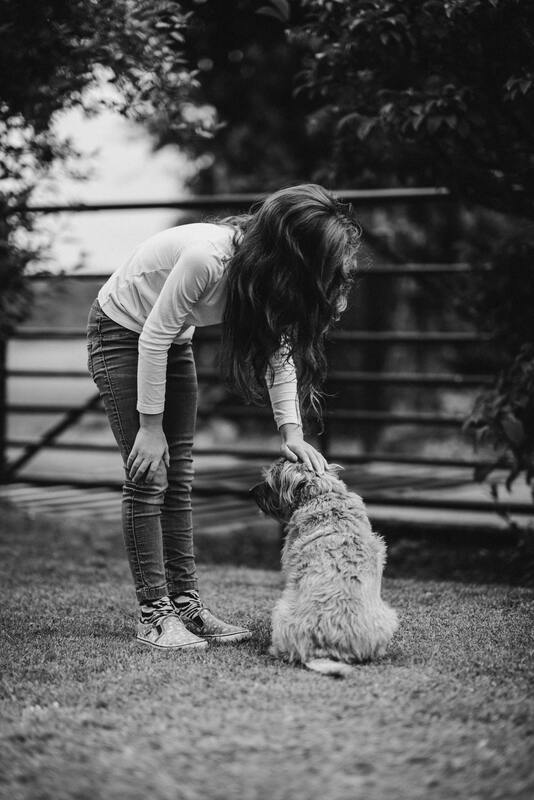 woman petting shaggy dog